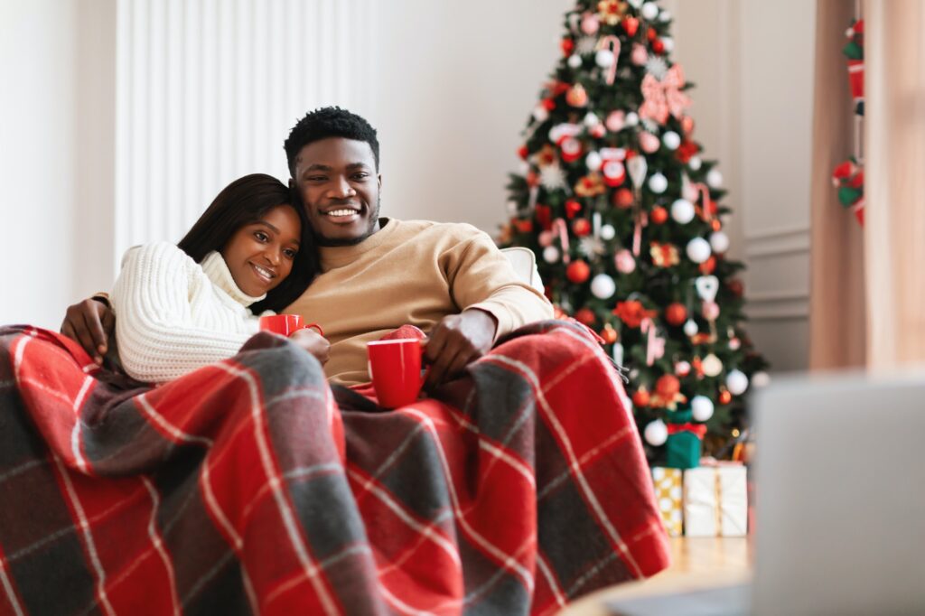 Portrait of happy black family watching tv on computer